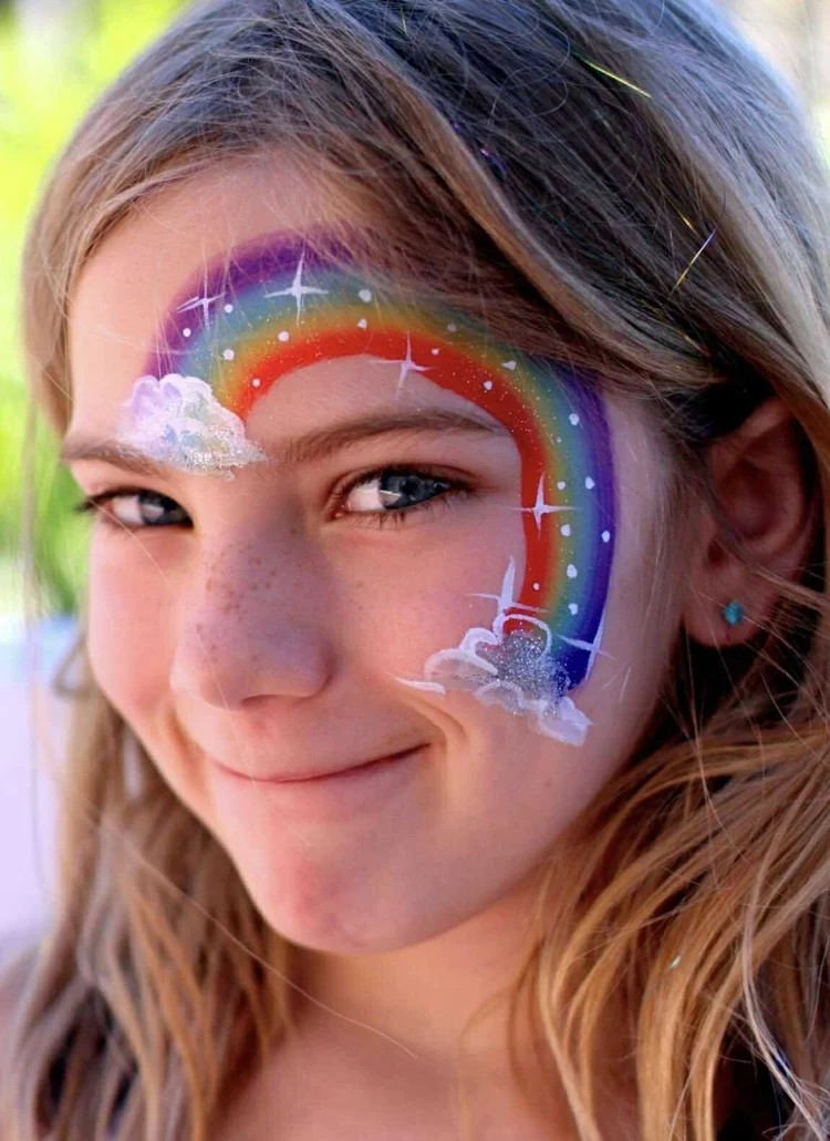 Rainbow face painting design for a children's party in Texas