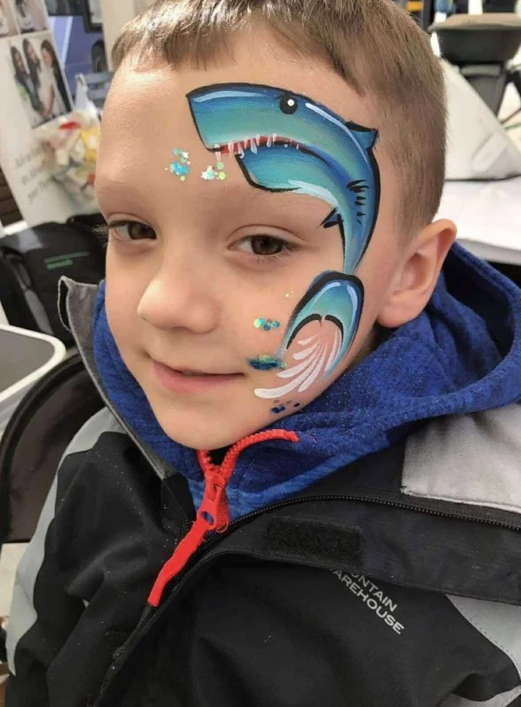 Shark face painting design for a boys birthday party in Texas